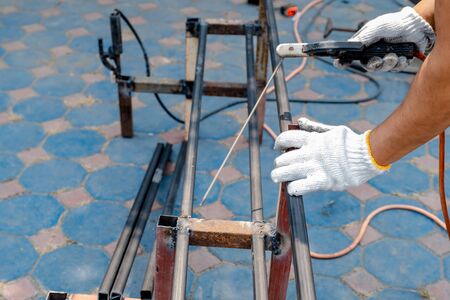 The mechanic is using a welding machine to weld steel.
