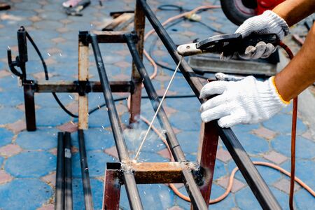 The mechanic is using a welding machine to weld steel.