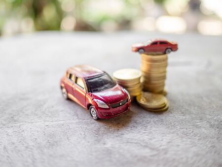 Red cars with golden coins pile, business cars, Insurance, rent concept.の写真素材