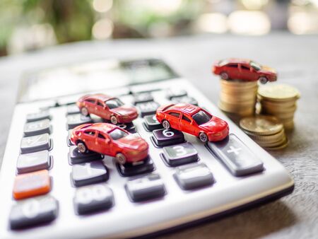 Red cars with golden coins pile and calculator, business cars, Insurance, rent concept.の写真素材