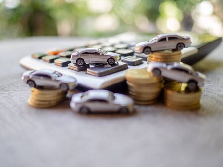 White cars with golden coins pile and calculator, business cars, Insurance, rent concept.の写真素材