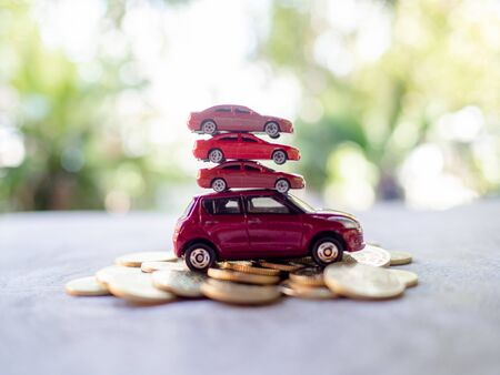 Red cars with golden coins pile, business cars, Insurance, rent concept.の写真素材