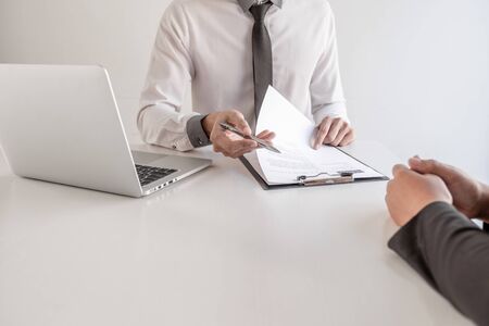 Office executives are interviewing job applicants in the meeting room.の写真素材