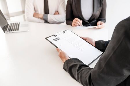 Office executives are interviewing job applicants in the meeting room.の写真素材