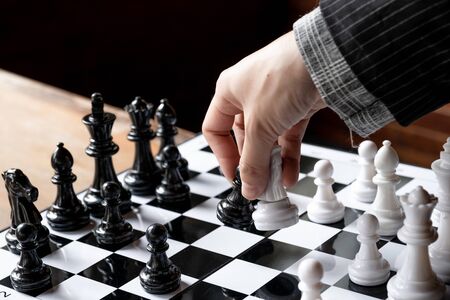 Business women play chess on board with white background, challenges planning business strategy to...