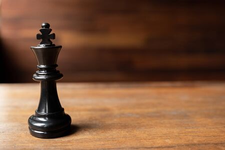 Black king chess on the wooden background, Leader, challenges planning business strategy to success concept.の写真素材