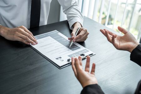 Office executives are interviewing job applicants in the meeting room.