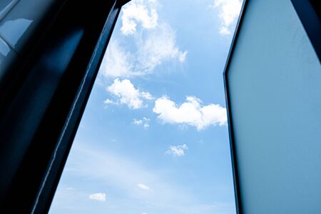 White clouds outside the window in the beautiful blue sky.