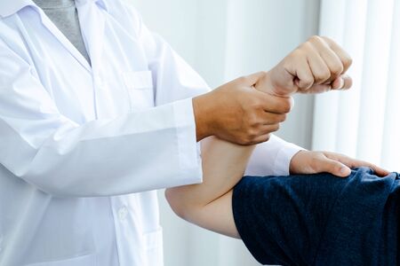 Physical therapy is doing hand therapy for patients in the hospital. and elbow therapy for patients in the hospital.の写真素材