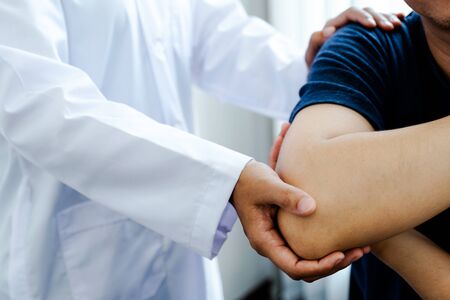 Physical therapy is doing shoulder and elbow therapy for patients in the hospital.の写真素材