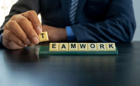 Professional executive businessman people wearing black suit holding success character in office. Show leadership, confidence, and celebrating.の写真素材