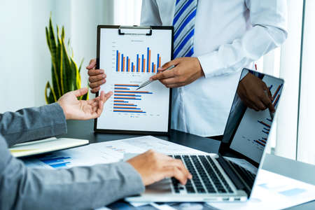 businessmen and businesswomen team meeting to plan strategies to increase business income. Have a...