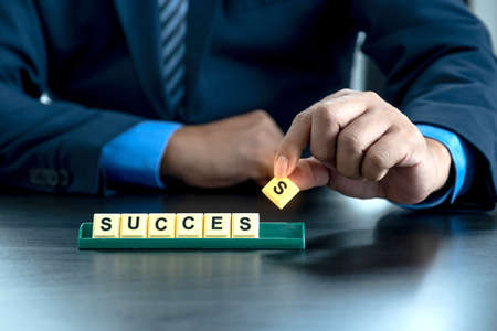 Professional executive businessman people wearing black suit holding success character in office. Show leadership, confidence, and celebrating.の写真素材