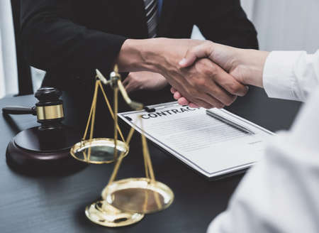 handshake after the male lawyer is providing service to consult business dispute to businessman.