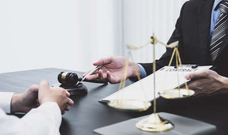 The male lawyer is providing service to consult business dispute to businessman.の写真素材