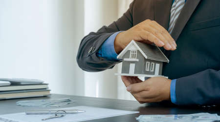 Hand a real estate agent, hold the home model, and explain the business contract, rent, buy,...