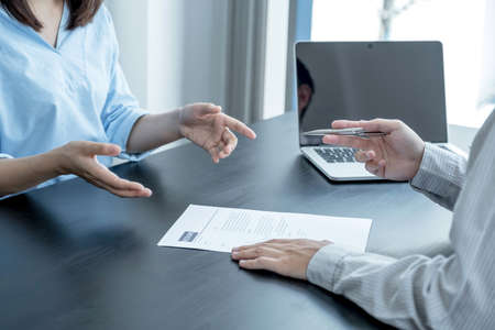 Business office executives are interviewing job applicants in the meeting room.
