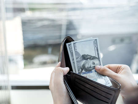 women person hands open the wallet and take purse dollar note out of.の写真素材