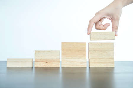 Hand holding blocks wood game, Concept Risk of management and strategy plan, growth business success...
