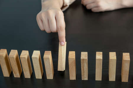Hand holding blocks wood game, Concept Risk of management and strategy plan, growth business success...