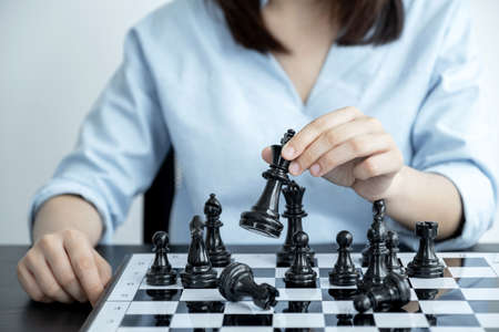 hand move chess with strategy and tactic to win enemy, play battle on board game, business opportunity  competition strategic challenge concept.の写真素材