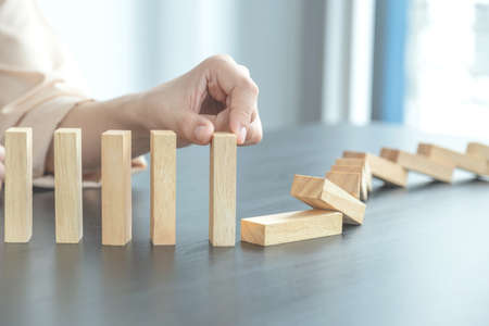 Hand holding blocks wood game, Concept Risk of management and strategy plan, growth business success...