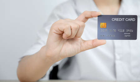 Businessman hand holding credit card to online shopping from home