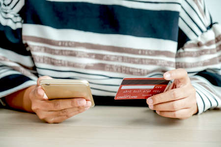 Businesswoman hand holding credit card to online shopping from home, payment ecommerce, internet...