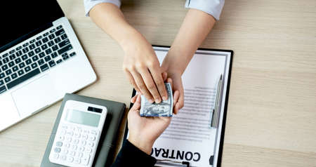 Government officials receiving bribe money from business man the concept of corruption and anti bribery.の写真素材