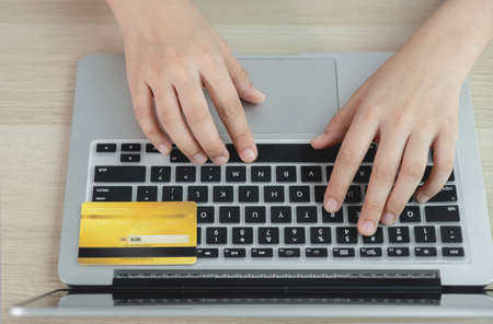 Businesswoman hand online shopping on laptop computer from home with credit card, payment...