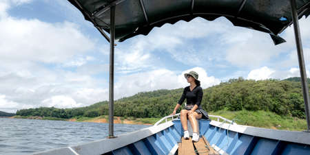 Tourist Asian young woman sitting on boat travel as dream lifestyle people happy luxury trip in vacation.の写真素材