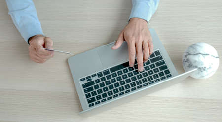 Businesswoman hand use laptop and holding credit card to online shopping from home