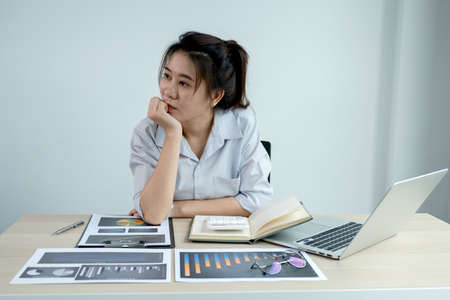 Businesswoman analysis the chart with laptop at the office for setting challenging business goals...