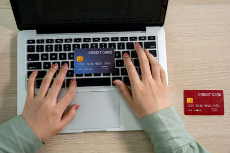 Businesswoman use credit card to online shopping from home with laptop, payment e-commerce, internet...