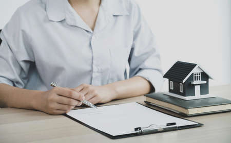 Real estate agent hand holding a pen, point to business contract, rent, buy, mortgage, loan, home...