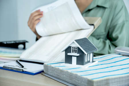 Home model standing in front of  the property and interior agents are presenting houses and curtains...