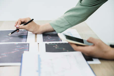 Trader businesswoman analyze stock graph and report, set targets for online forex trading market management success.の写真素材