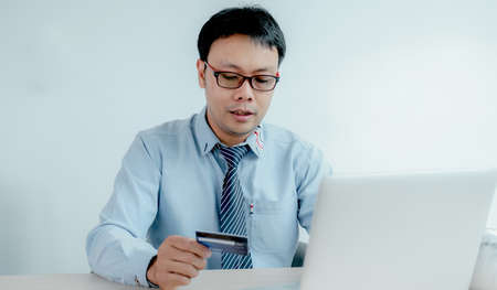 Businessman use credit card to online shopping from home with laptop, payment e-commerce, internet...