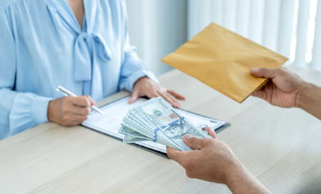 business man hand holding money and bribe to officials  the concept of corruption and anti bribery.