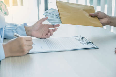 officials receiving bribe money from business man the concept of corruption and anti bribery.の写真素材