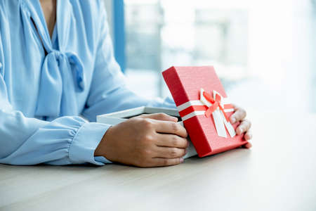 woman hands holding Gift box for giving at the festival of special holidays like Christmas, New Year...