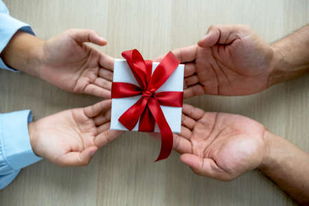 Gift box in hands, Men's hands are giving gifts to women's hands at the festival of special holidays...
