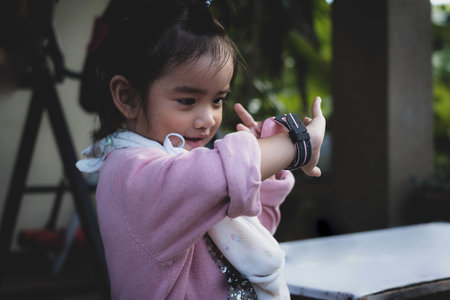 Asian kid use technology smart watches with happy faces.の写真素材