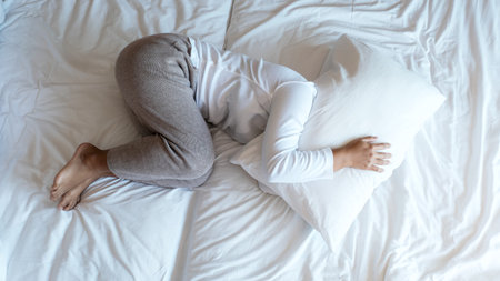Young Asian woman in plain t-shirts on the luxury white bed.