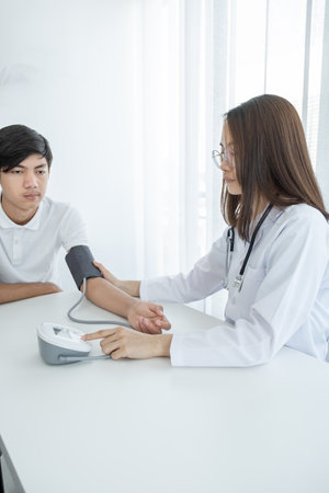 The doctor woman use the pulse meter to measure the pressure of the patient, medical checkup conceptの写真素材