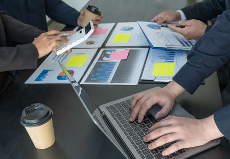 hand use laptop, businesswomen and businessmen team meeting to plan strategies to increase business...