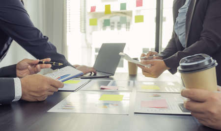 hand holding graph, businesswomen and businessmen team meeting to plan strategies to increase business income. Have a brainstorming finance graph analysis and discussing for the new target success.の写真素材