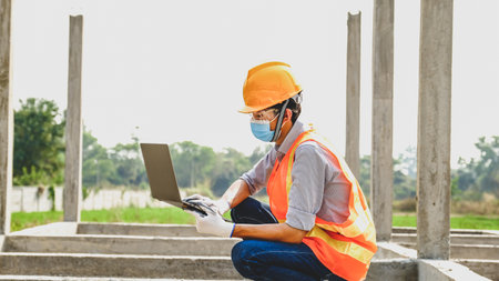 Engineer contractor man use lptop work safety industry project, check house plan design and...