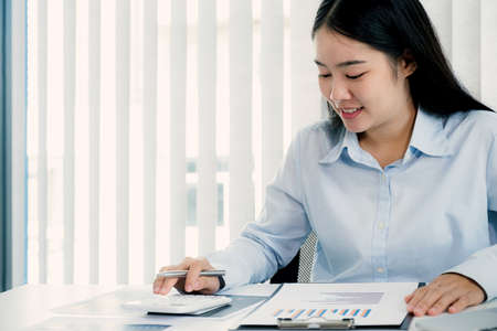 Businesswoman analysis the chart and meeting Video Conferencing with laptop at the home office for setting challenging business goals And planning to achieve the new target.の写真素材