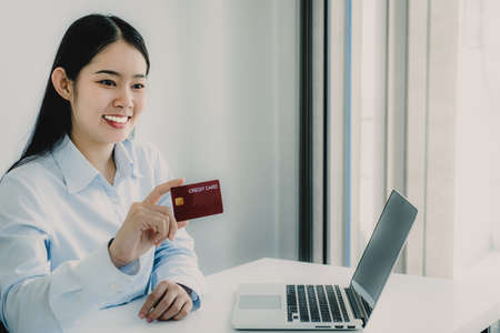 Young Asian consumer woman hand holding a credit card, Ready to spending pay online shopping...
